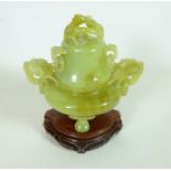 20th Century Chinese carved jade Koro with dragon handles and finial on carved wood stand,