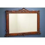 Carved hardwood framed overmantel mirror with bevelled glass,