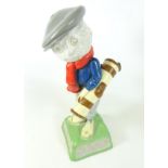 Dunlop Caddie figure carrying a golf bag with three clubs, inscribed “We play Dunlop" to the base,