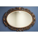 20th century carved oak framed oval mirror, bevelled glass,