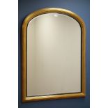 Gilt framed overmantel mirror with arched top and bevelled glass,