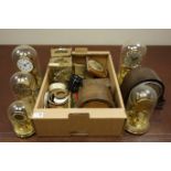 Various torsion clocks under glass domes and other clock related items in two boxes