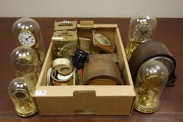 Various torsion clocks under glass domes and other clock related items in two boxes