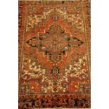 Persian Heriz red ground rug, geometric design,