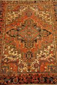 Persian Heriz red ground rug, geometric design,