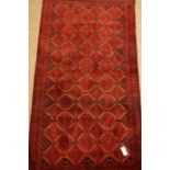 Baluchi red ground rug, repeating gul design,