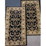 Pair Persian design black ground rugs,