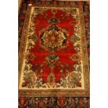 Persian Tabriz rug, cream ground with red field, within blue board, floral design,