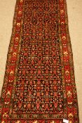 Iranian Veramin red ground runner rug, repeating herati motif,
