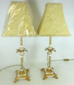 Pair of gilt table lamps with palm leaf decoration on scroll feet,