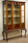 Edwardian mahogany display cabinet, glazed concave centre, two doors, on cabriole supports, W129cm,