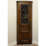 Medium oak corner display cabinet, lead glazed door above single cupboard, W65cm,