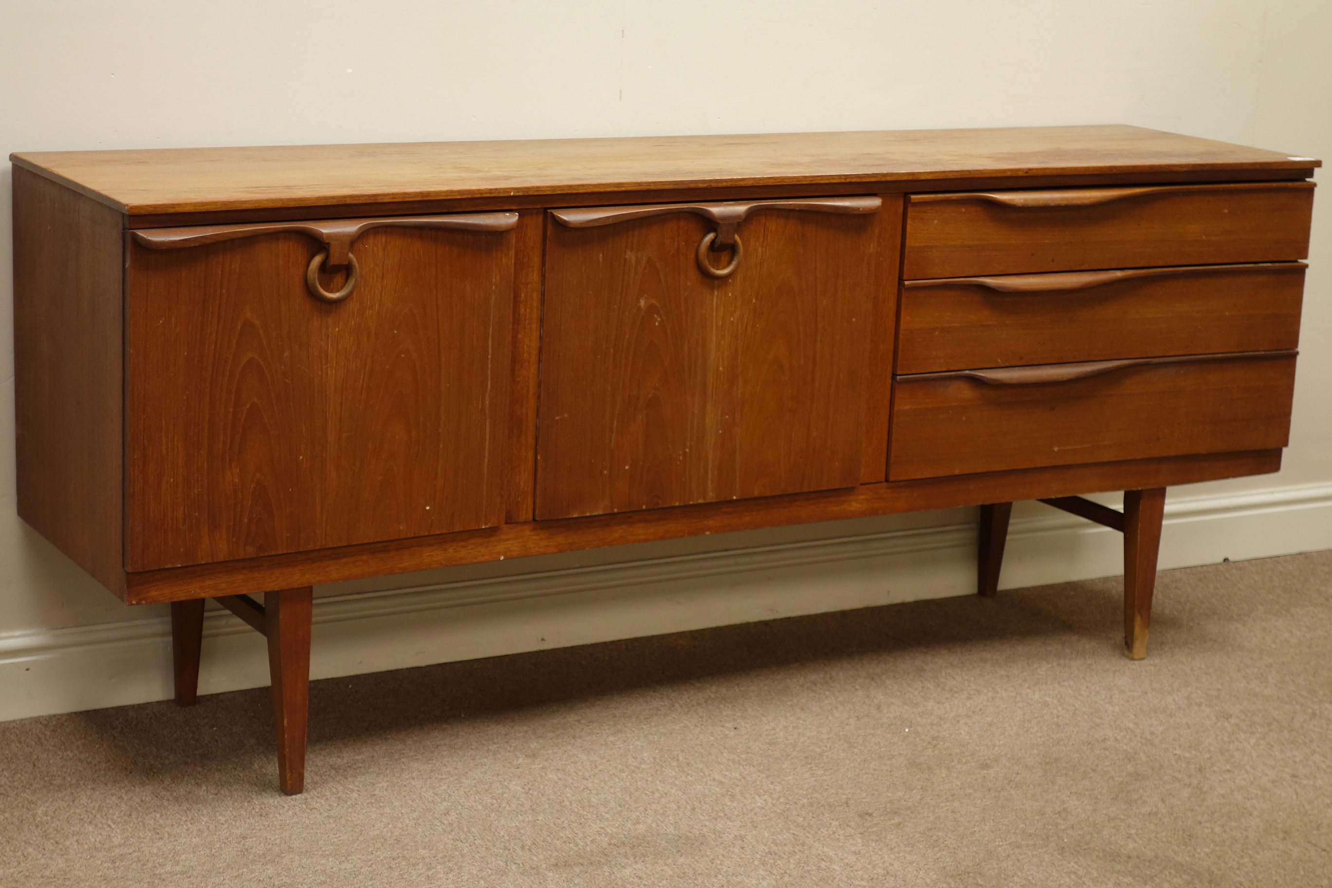 1970s Beautility teak sideboard, concave top, centre fall front compartment,