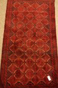 Baluchi red ground rug, repeating gul design,