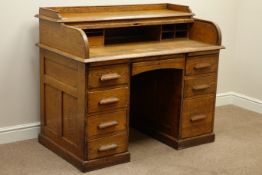Early 20th century oak tambour roll top desk, eight drawers, W123cm, H101cm,