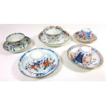 Five 19th Century Chinese tea bowls and saucers decorated in blue and iron red (5)