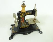 Early 20th Century German tinplate toy sewing machine with gilt decoration H22cm