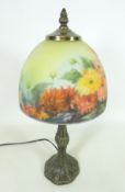 Bronze effect table lamp with a floral glass shade,