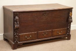 Early 19th century oak mule chest, hinged lid, with three drawers, carved foliate mounts and mask,