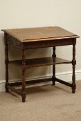 Early 20th century carved oak desk with sloped hinged lid, W69cm, H69cm,