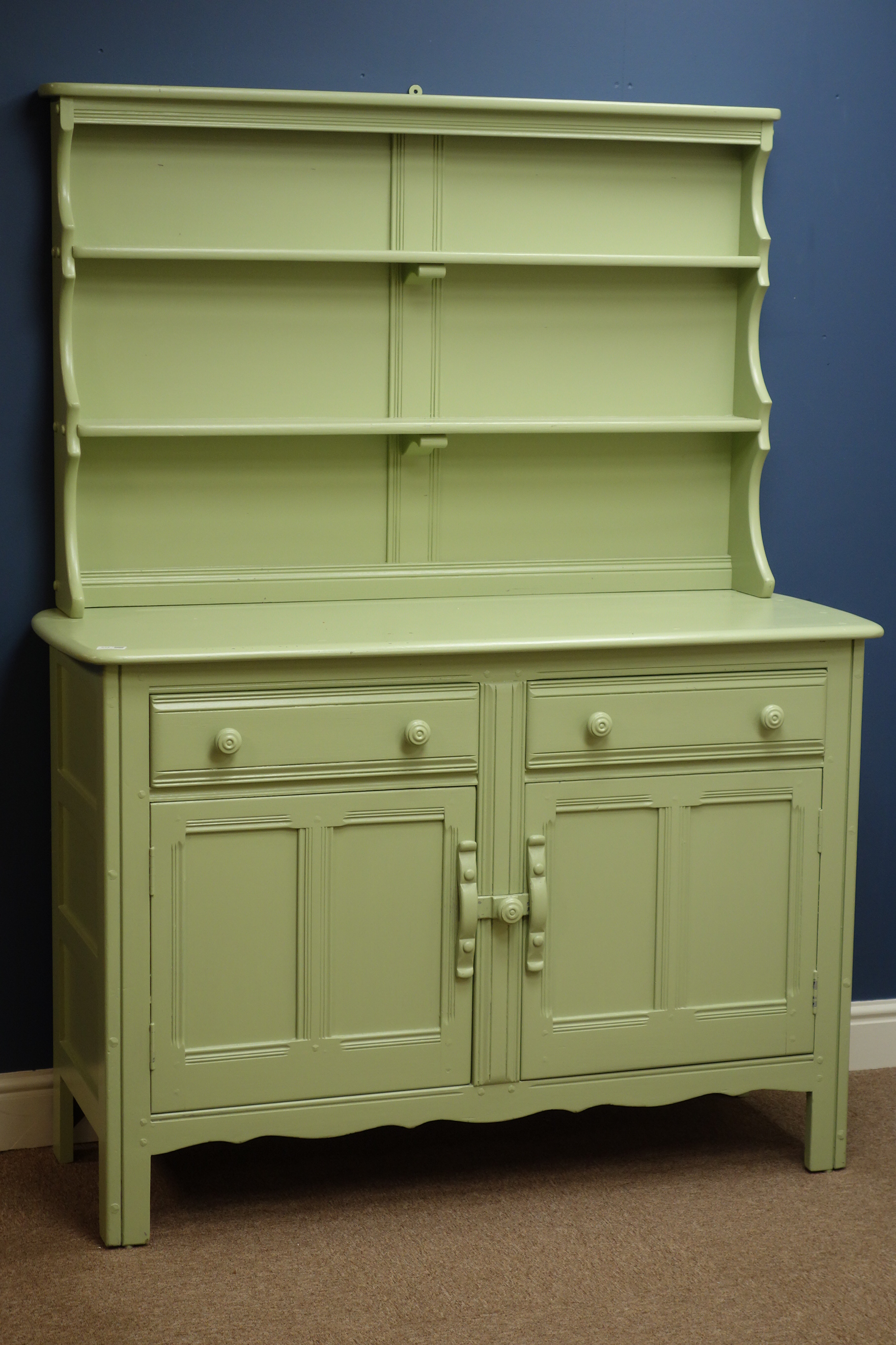 Ercol dresser, two drawers and two cupboards, raised two heights plate rack, painted in green,