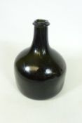 Early 18th Century 'onion' shaped dark olive green bottle of squat form with short stem and kick up