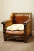 Early 20th century carved oak armchair, upholstered in antique leather with fabric loose cushions,
