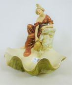 A Royal Dux figure of a maiden collecting water from a spring above a shell shaped base,