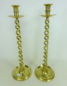 Pair of tall brass twisted stem candle sticks,