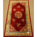 Red ground Chinese washed woollen rug,