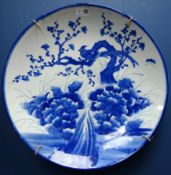 Large Japanese Arita porcelain charger decorated with an exotic bird, insects and cherry blossom.