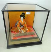 Japanese Geisha model in glass display case,