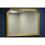 Gilt framed wall mirror with shaped top,