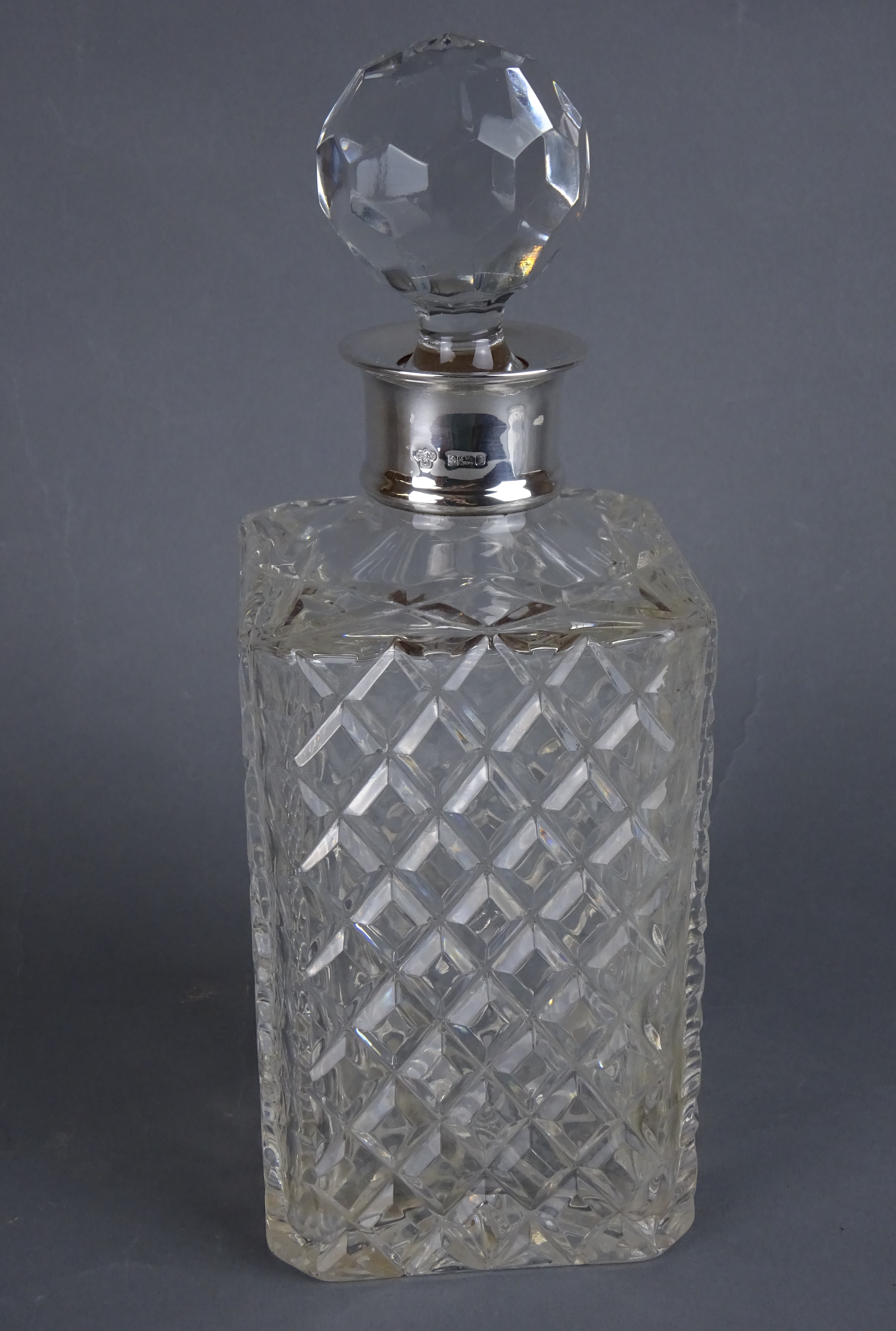 Cut glass decanter with hallmarked silver collar by C. J.
