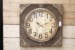 Industrial wall clock, pierced metal frame with circular dial,