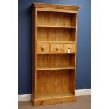 Traditional pine four tier book case with three centre drawers, W85cm, H176cm,