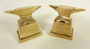 Two bronze anvil paperweights with stands,