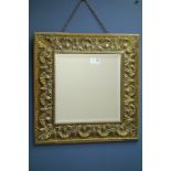 Early 20th century embossed brass mirror with bevelled glass,