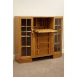 Mid 20th century light oak secritere bookcase, fall front with fitted interior above four drawer,
