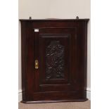 20th century hardwood wall hanging corner cupboard, carved dragon to panelled door, W69cm,