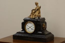Late 19th century black slate mantel clock with gilt metal seated maiden figure,