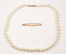 Gold bar brooch set with a pearl hallmarked 9ct and a string of pearls the clasp stamped JKa 9ct