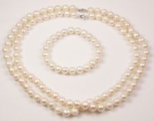 Double string of freshwater pearls the clasps stamped 925 and a matching bracelet