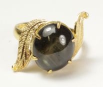 Leaf scroll ring set with a black star sapphire tested to 18ct Condition Report