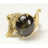 Leaf scroll ring set with a black star sapphire tested to 18ct Condition Report