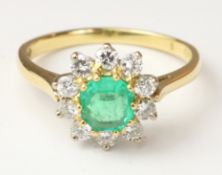 Emerald and diamond cluster ring hallmarked 18ct Condition Report <a