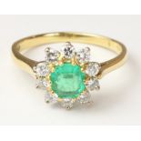 Emerald and diamond cluster ring hallmarked 18ct Condition Report <a