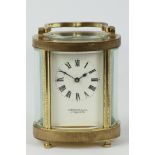 Mid 20th century brass carriage clock, oval form, 'Garrard & Co.