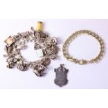 Silver bracelet London 1975 with approx 24 charms,