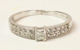 Hallmarked 18ct white gold ring set with princess cut central diamond and twenty further diamonds